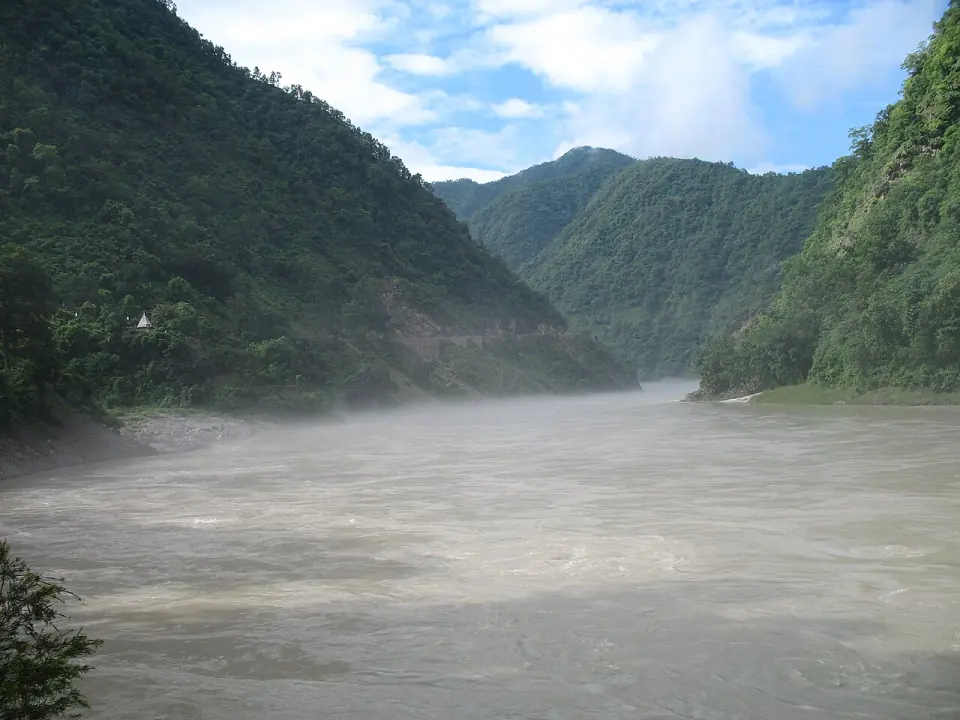 Misty morning on the broad Ganga flowing between forested hills at Kaudiyala, upstream of Rishikesh